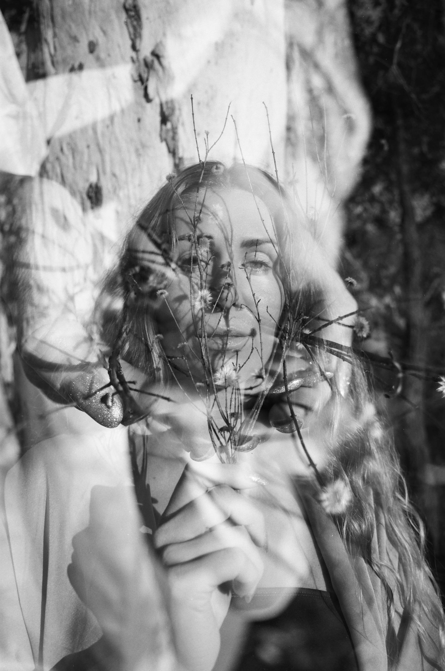 Grounded feminine portrait among cracked river stones — slow, intentional film shoot in the Perth Hills at sunrise.