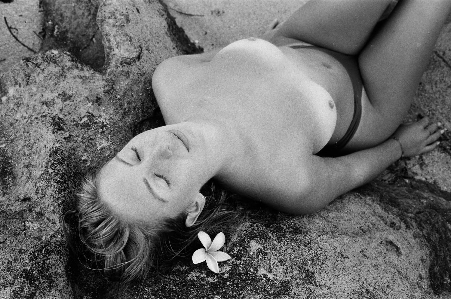 Emotive portrait of a woman embracing stillness on the rocks — shot on film at Mettam’s Pool, Western Australia.
