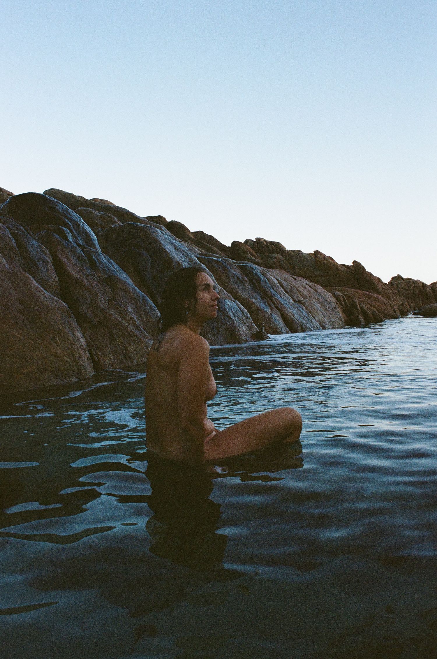 Grounded feminine portrait by the reef edge — slow and intentional session at Mettam’s Pool in Perth.
