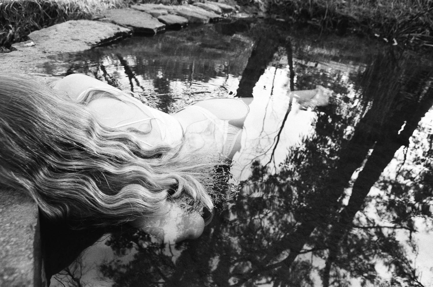 Film portrait of woman in quiet reflection at Lesmurdie Falls, serene natural light near Perth”