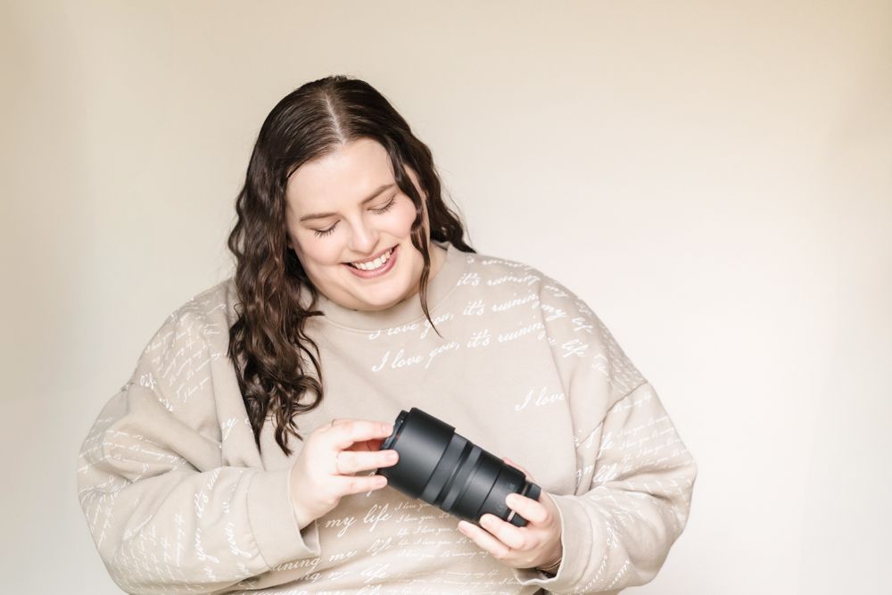 woman smiling at a camera lens