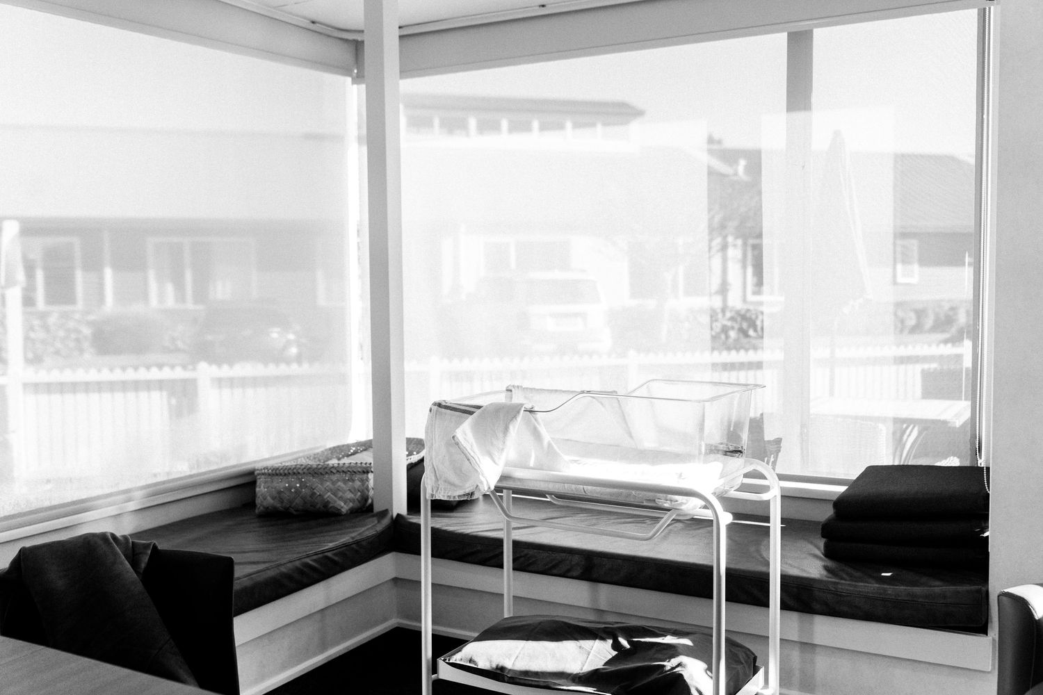 Black and white photo of a bright hospital room corner by Nelson Newborn Photographer