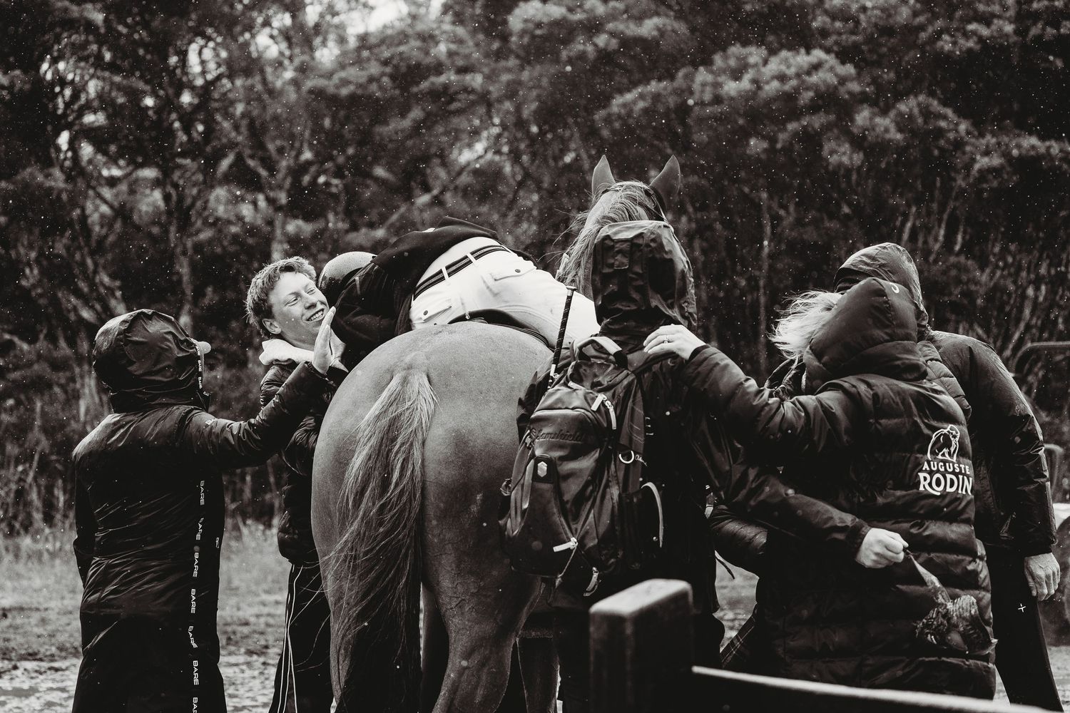 Australian jumping championships at boneo park. Riders, family and grooms celebrating. Black and white image in the rain.