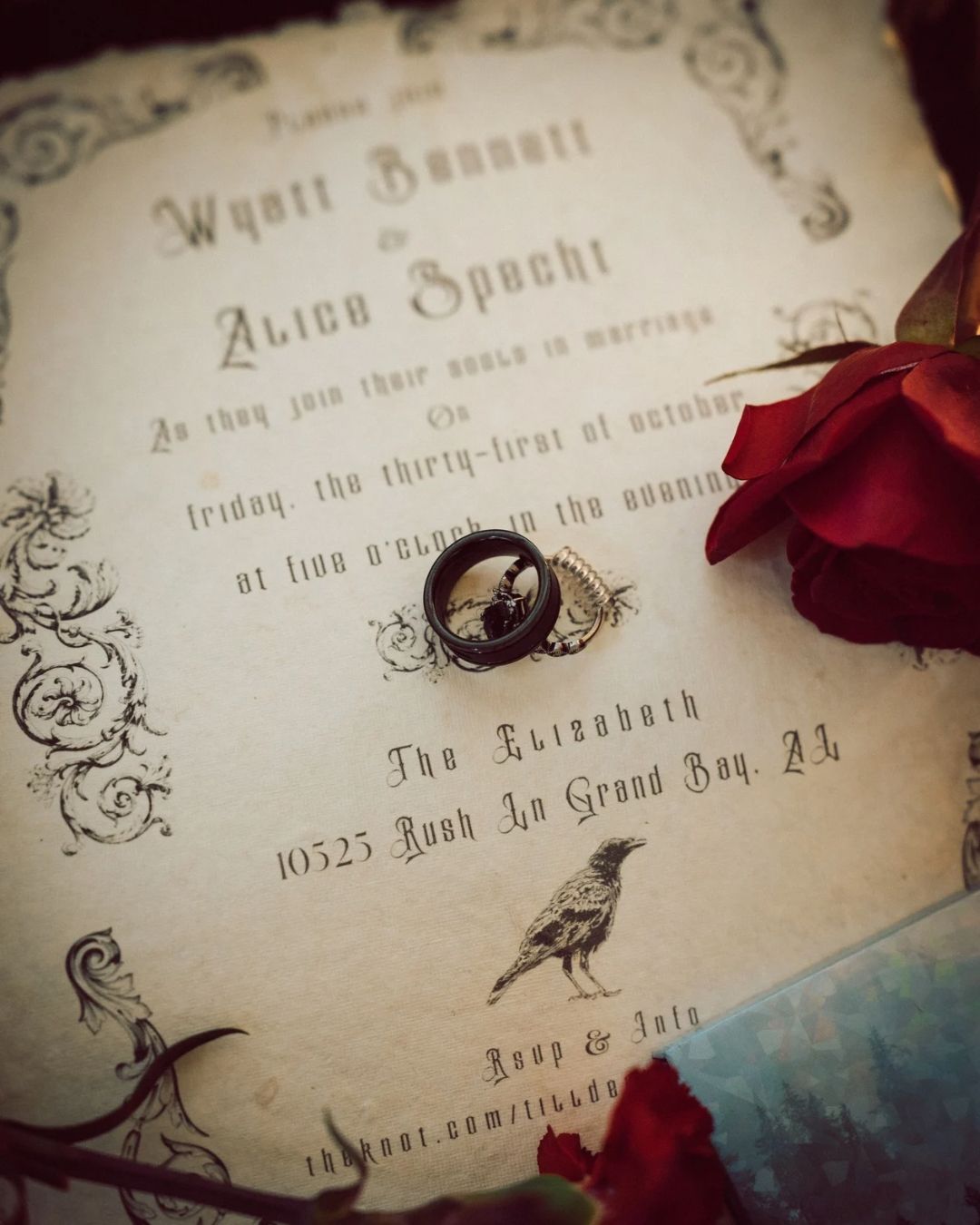 Gothic wedding invitation for Wyatt Bennett and Alice Specht with a black ring and red rose on aged paper.