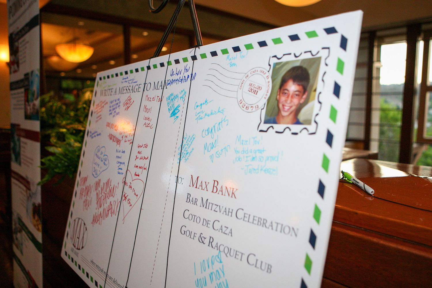 Large decorative postcard guest book display at Max Bank's Bar Mitzvah celebration at Coto de Caza Golf & Racquet Club.