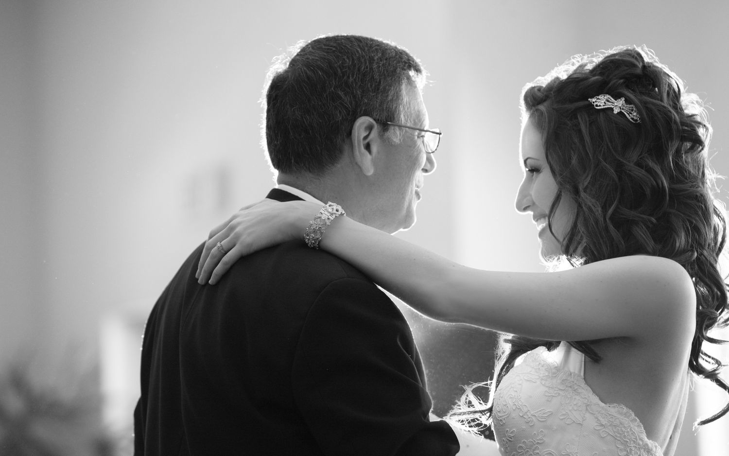 Black and white photo of a bride and groom sharing an intimate moment during their wedding ceremony.