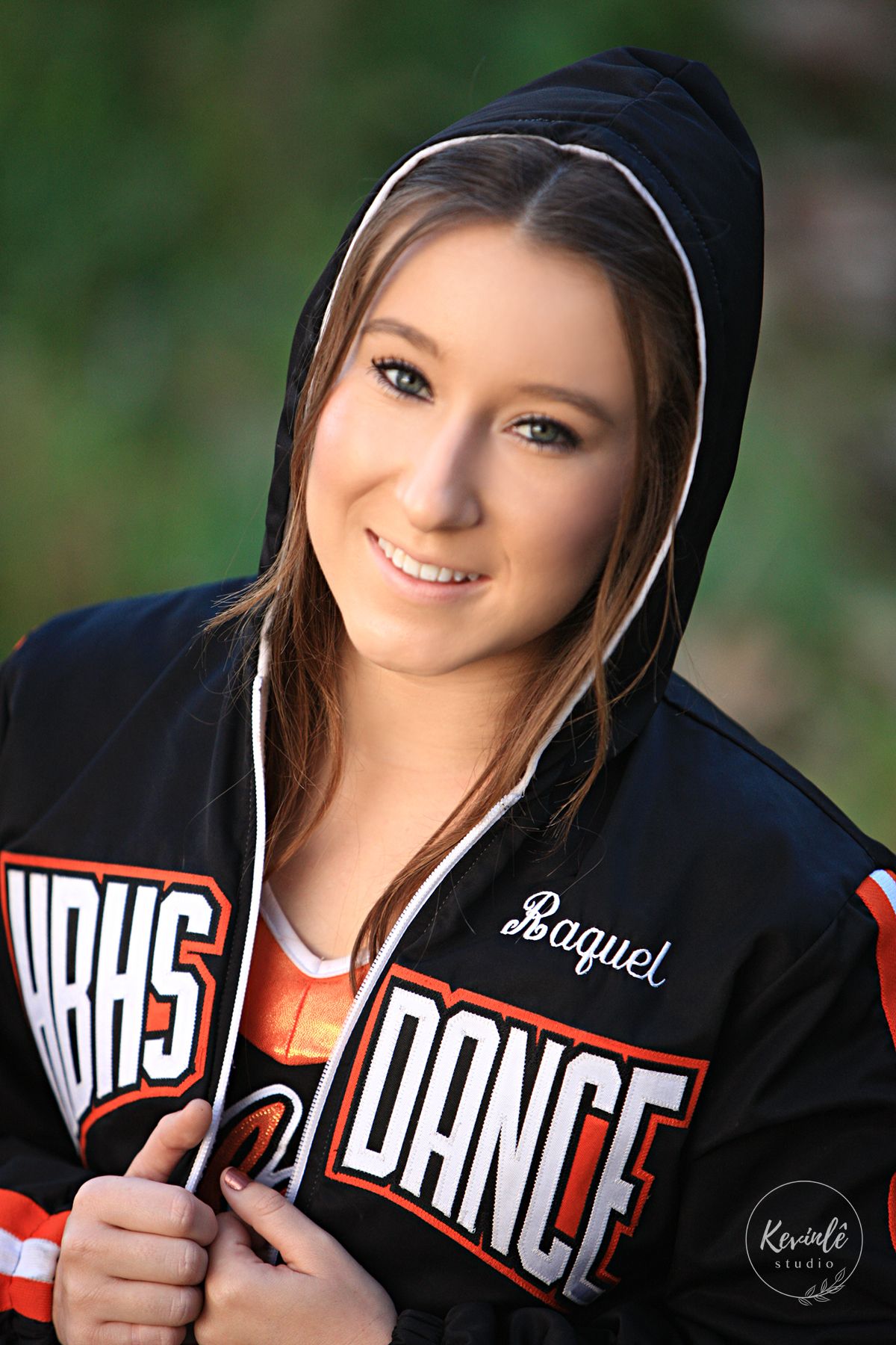 Young woman named Raquel smiling in a black VBHS Dance team hoodie jacket outdoors.