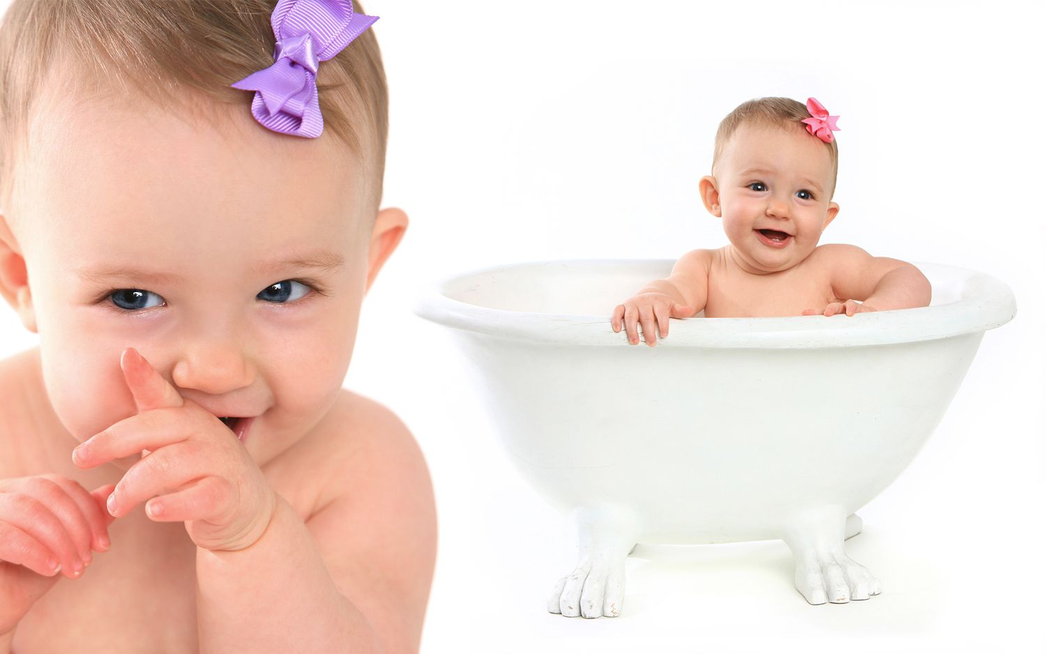Cute baby girl with pink bow sitting in a white clawfoot bathtub.