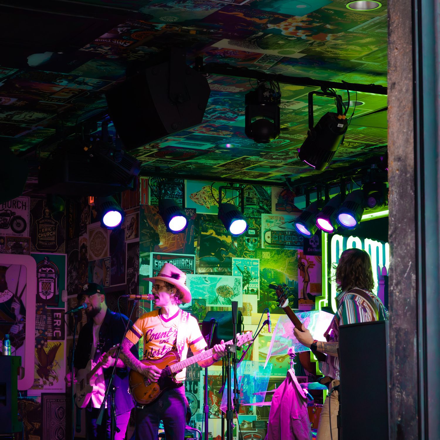 Band photographed in a performance‑inspired setting with dynamic lighting and expressive posing.