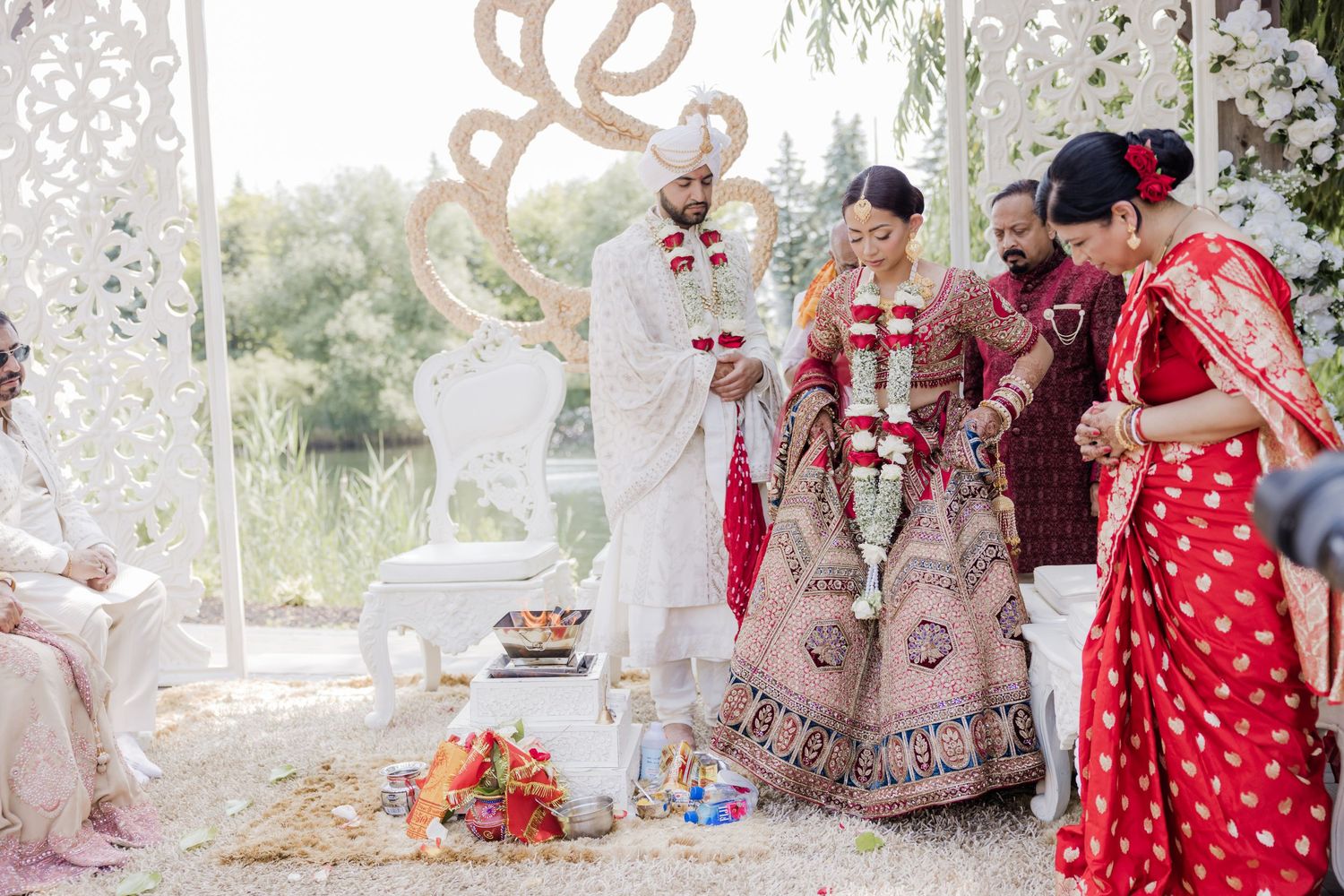 A series of wedding photos showing traditional Indian ceremony details and decorations in warm red and gold colors.