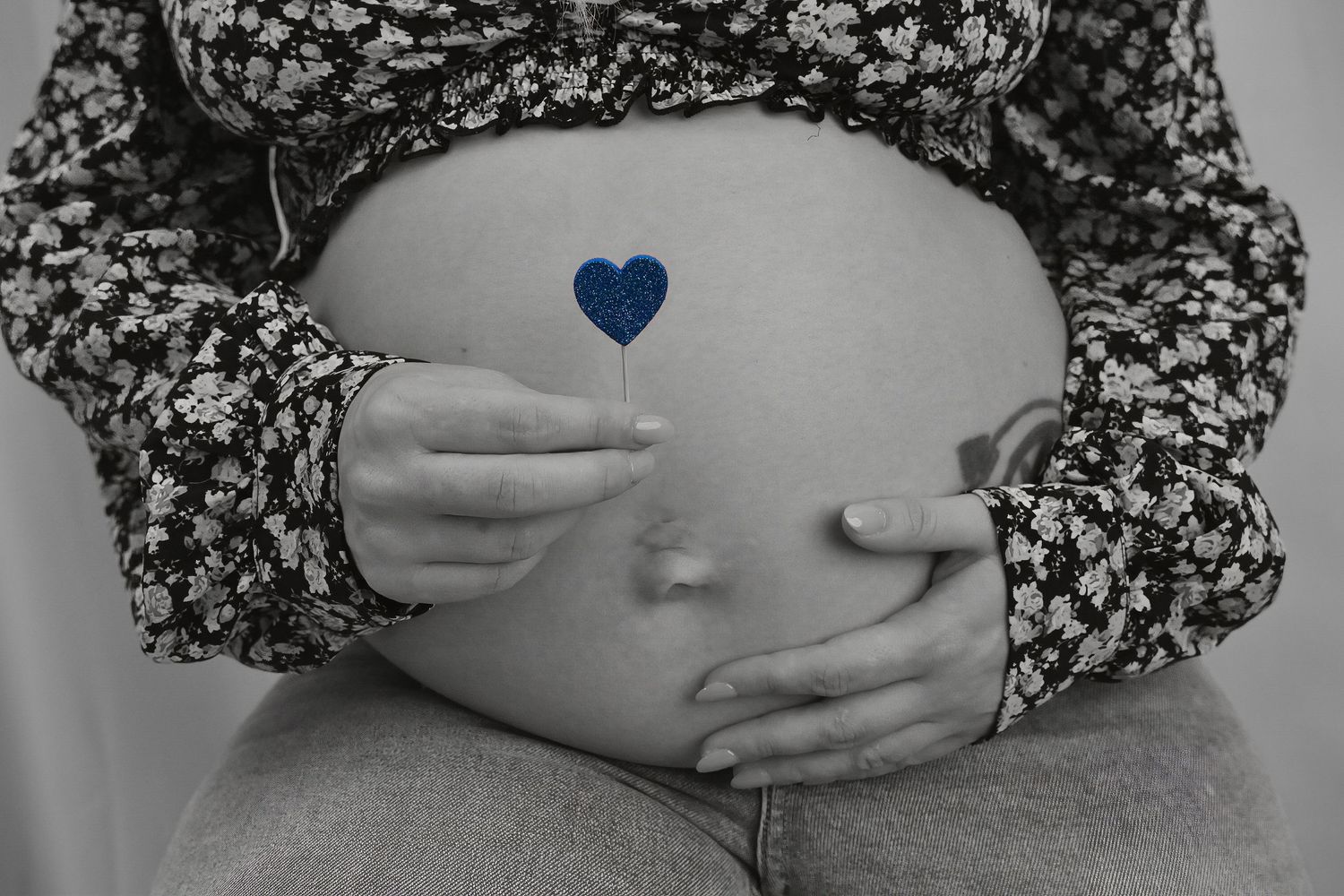 A person wearing a floral print top holds their hands over their heart in a series of sequential photos.