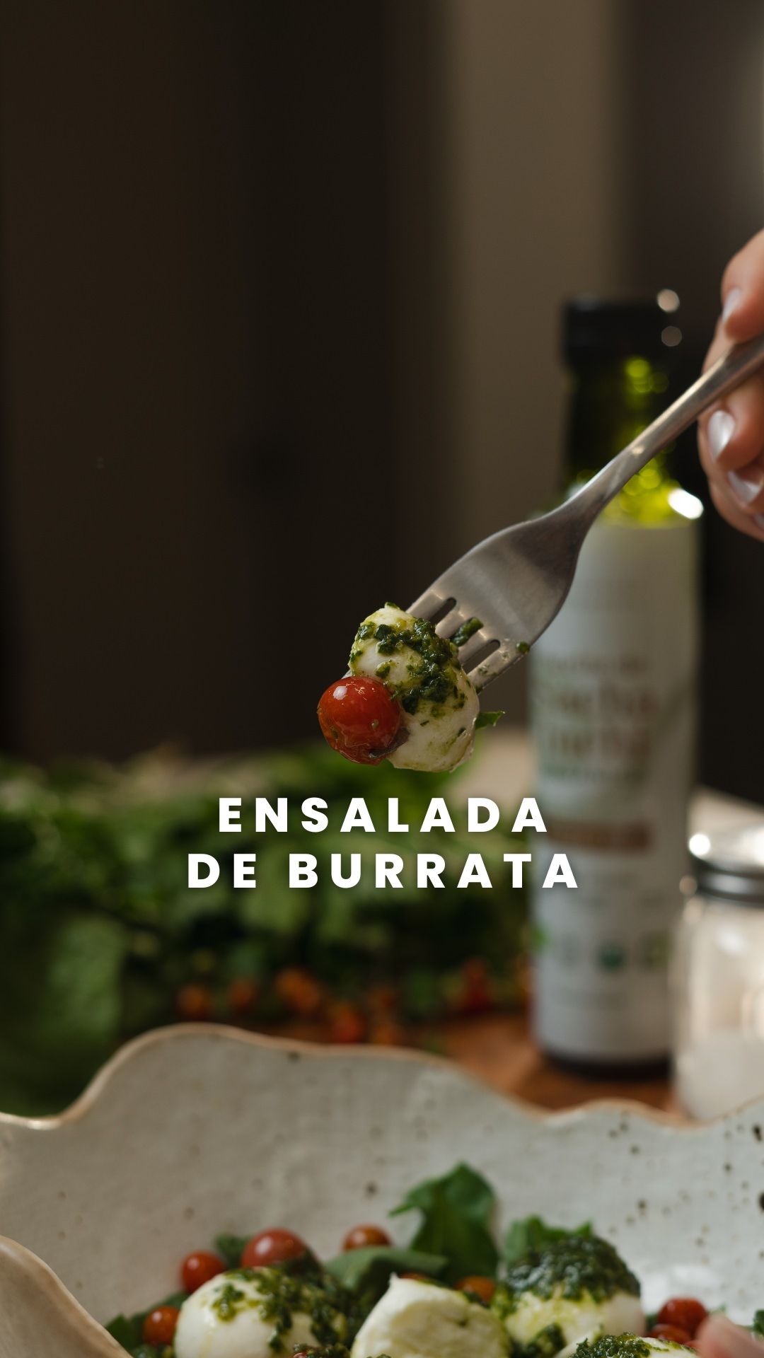 Fork lifting a bite of burrata salad with text overlay showing recipe name.