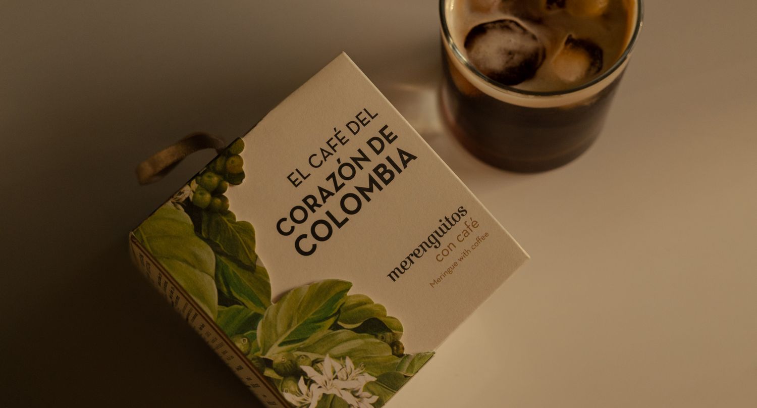 Package of Costa Rica coffee with floral artwork next to dark beverage.