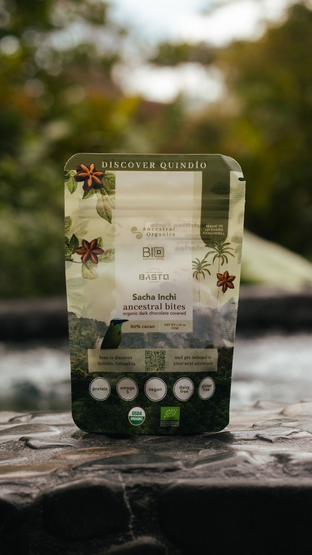 Organic tea packaging with floral design and Discover Quindio branding on a wooden surface.