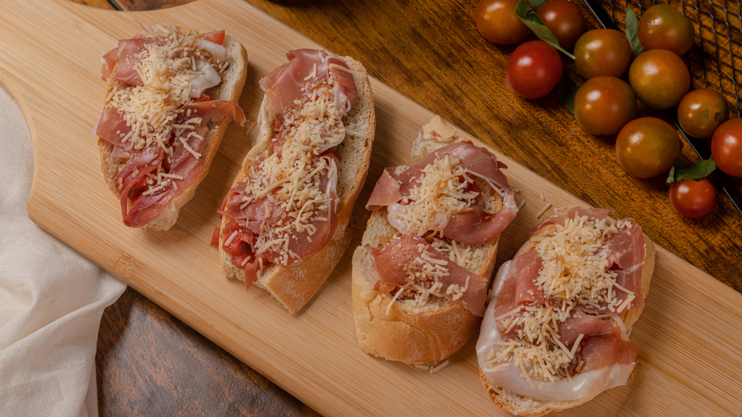 Raw seasoned chicken breasts arranged on wooden cutting board.