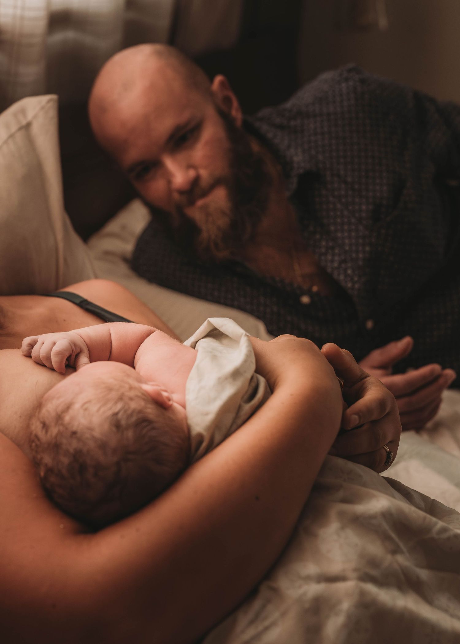 A tender newborn moment captured in warm, intimate lighting.