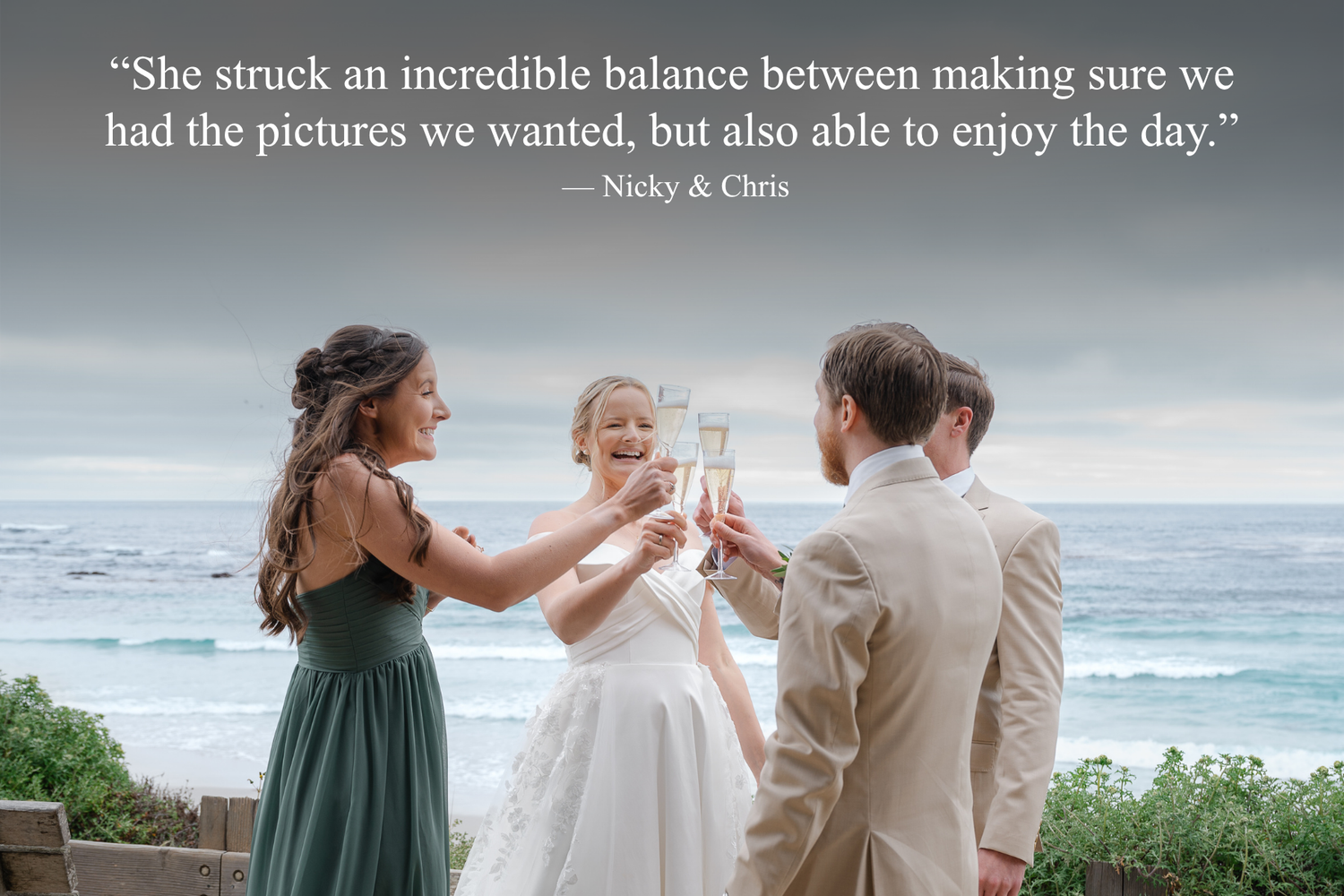Wedding party toasting with champagne outdoors by the ocean, bride in white gown with bridesmaid and groomsman celebrating.