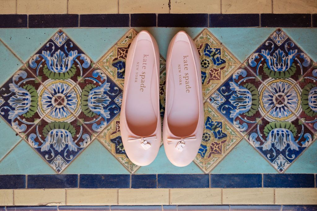Decorative blue and white ceramic tiles with intricate floral patterns line a wall in a traditional Mediterranean style.