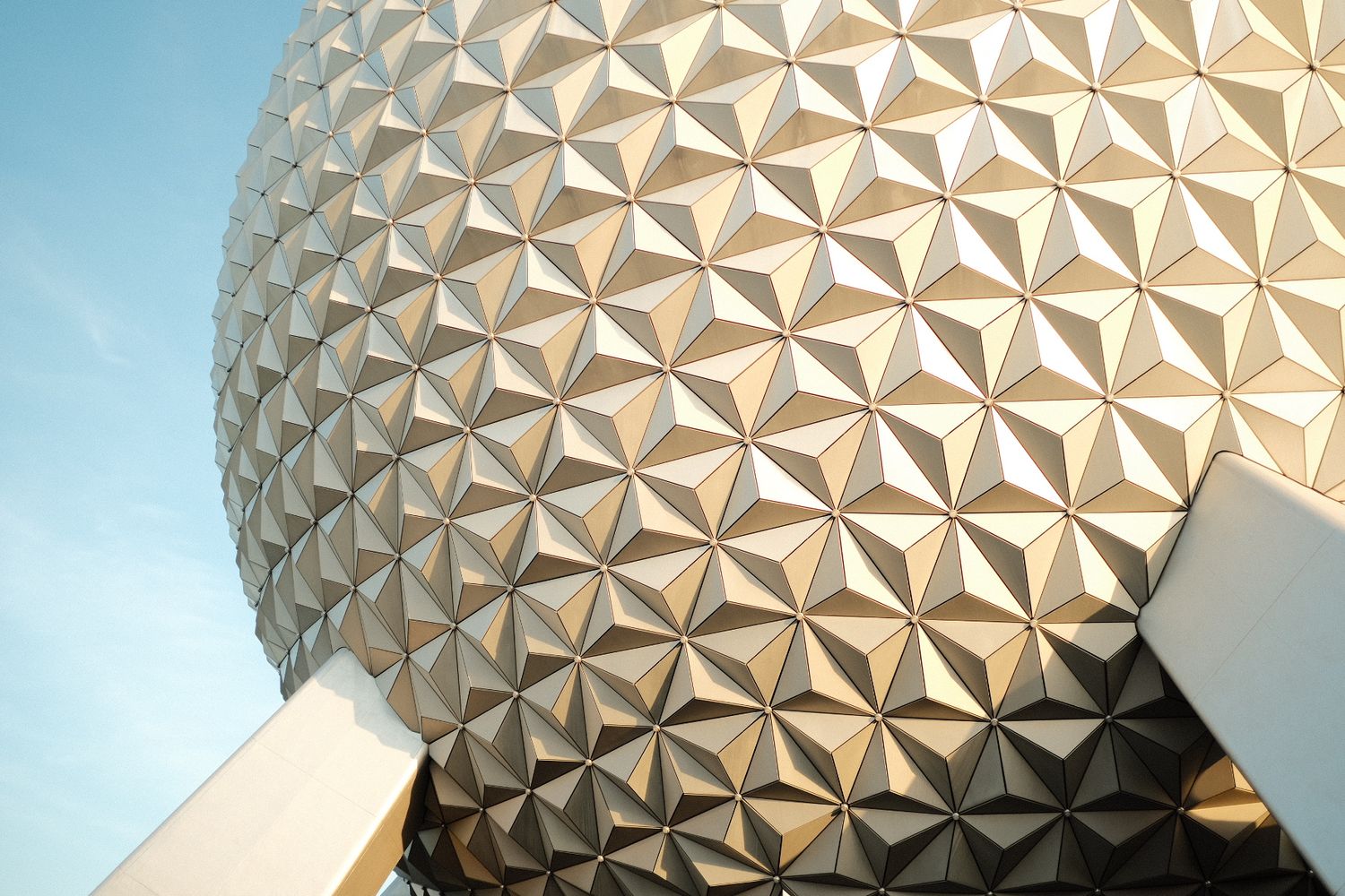 Close-up view of Spaceship Earth geodesic sphere at EPCOT, Walt Disney World, against a clear blue sky.