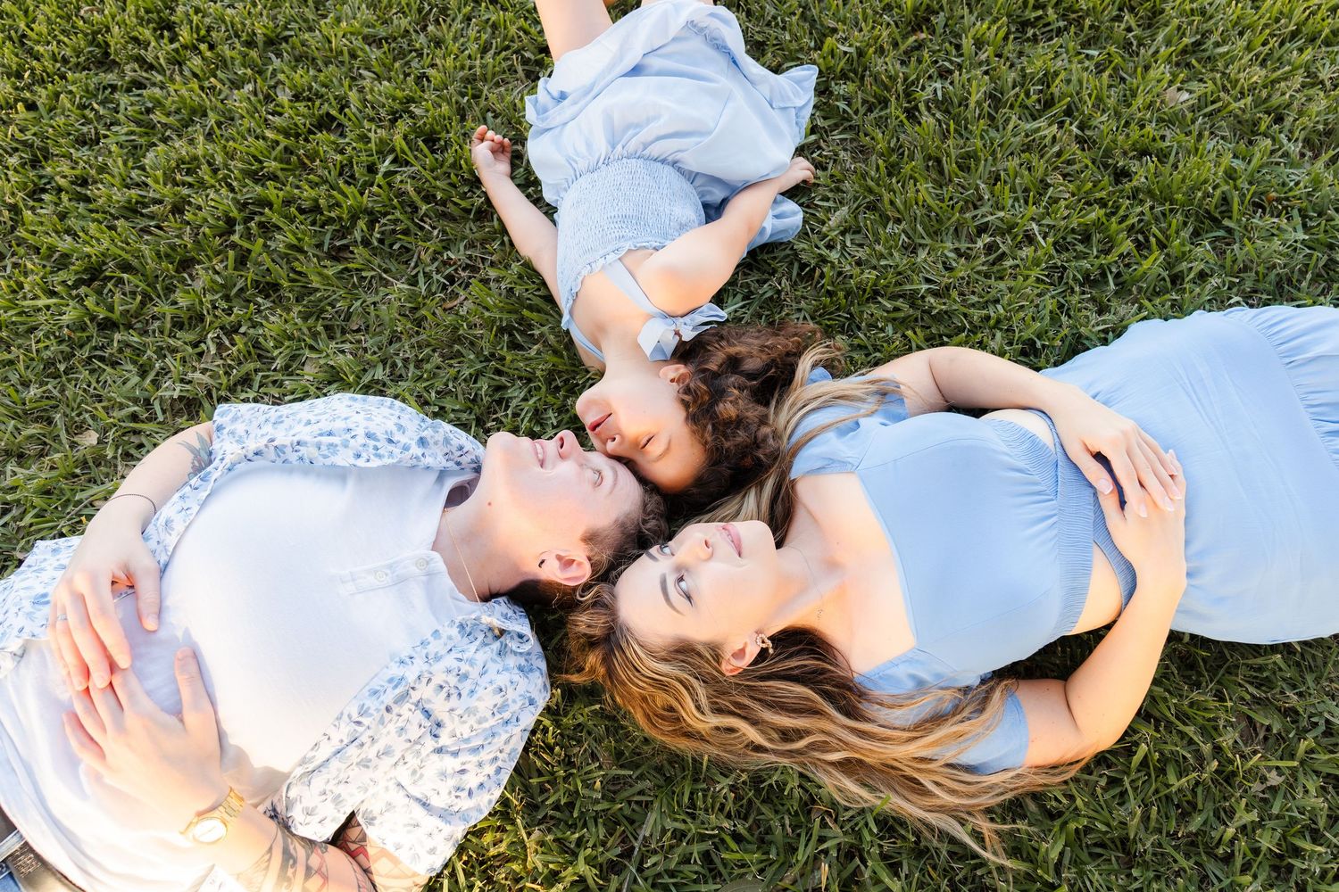 A sequence of photos showing a person lying in green grass wearing light blue clothing and relaxing in nature.