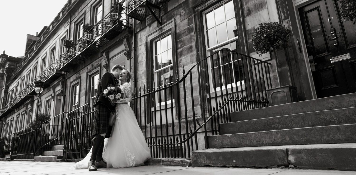 A row of black and white street photographs showing historic brownstone buildings with ornate railings and staircases.
