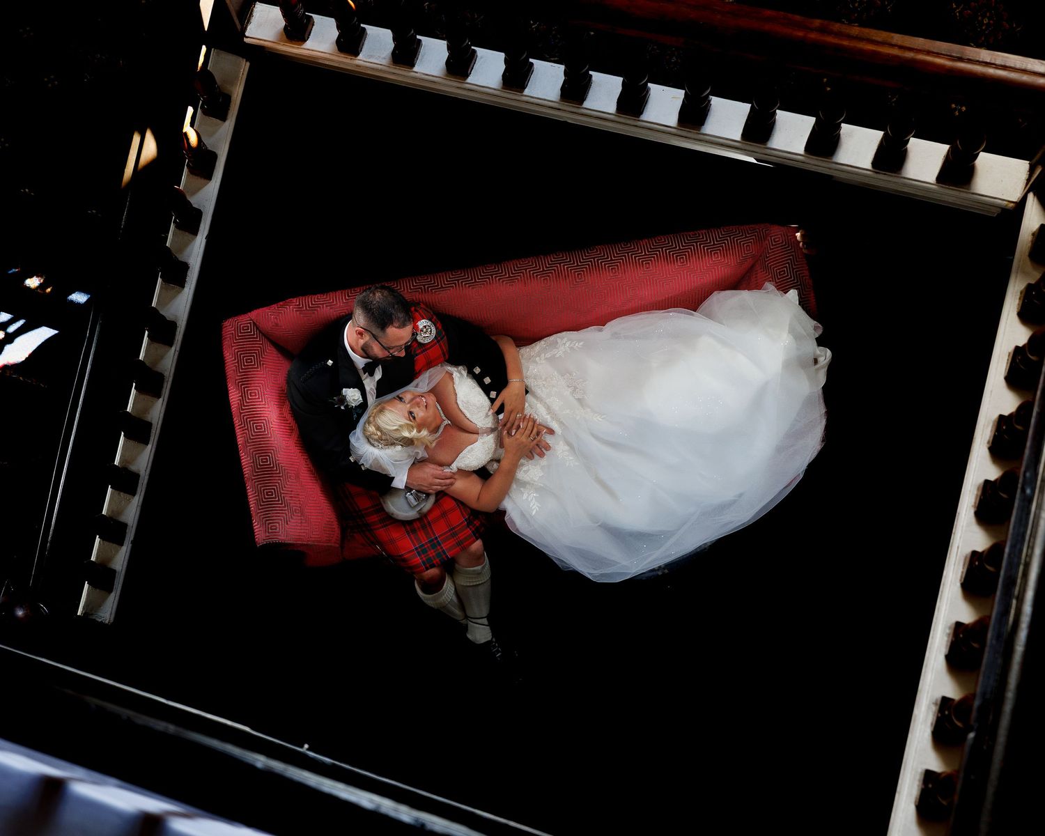 Waterton Park Hotel - Artistic overhead wedding photography with dramatic black background and lighting.