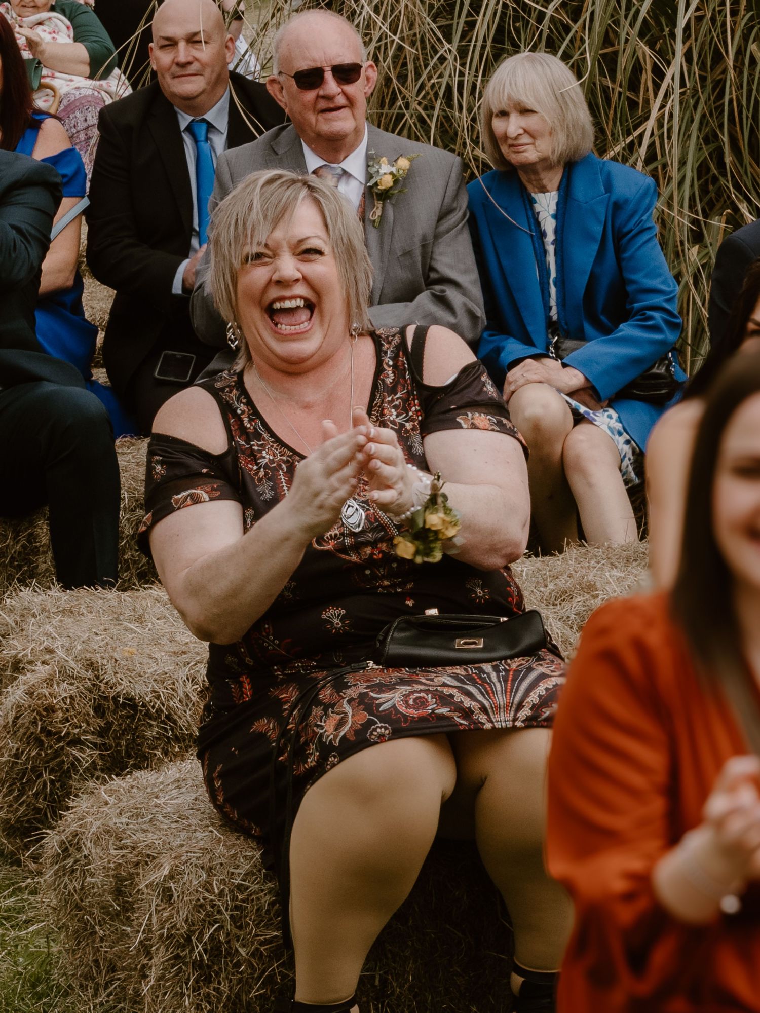 Fishmill Lake Doncaster - Wedding guests laughing and enjoying themselves during an outdoor ceremony.