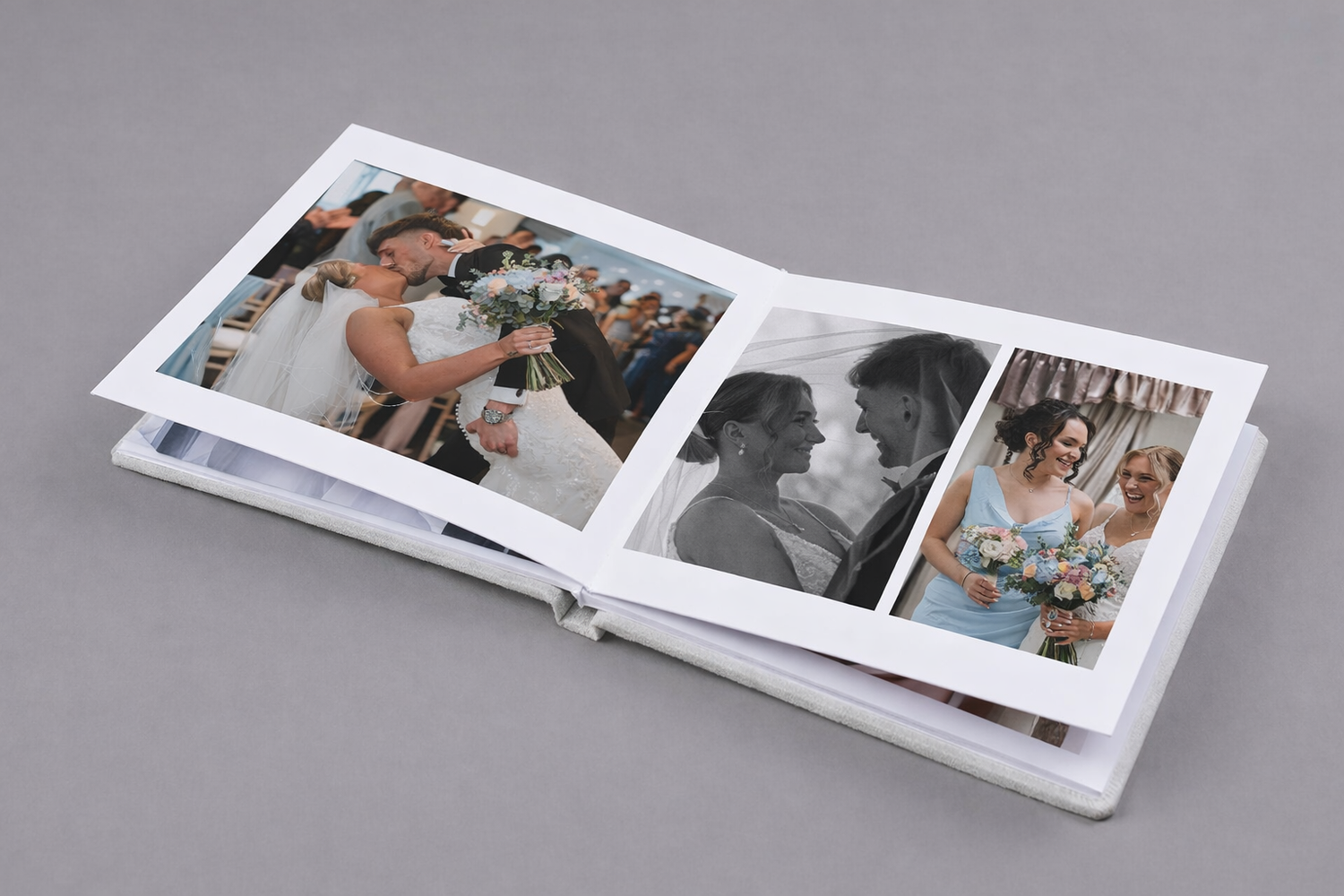 Open wedding photo album displaying bride and groom ceremony moments in color and black and white prints.