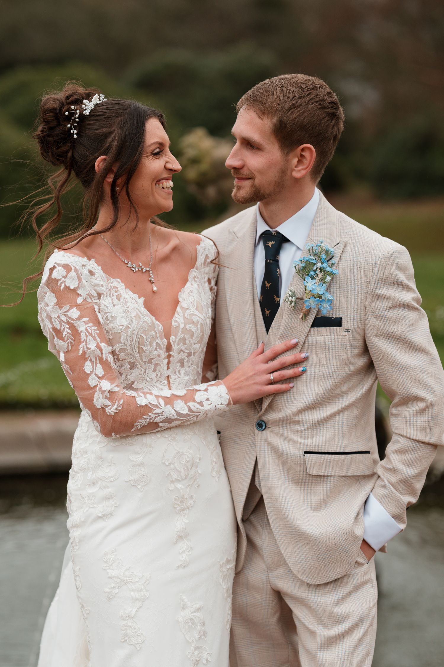 Newlywed couple shares intimate moments in a series of romantic outdoor wedding photos by a lake.