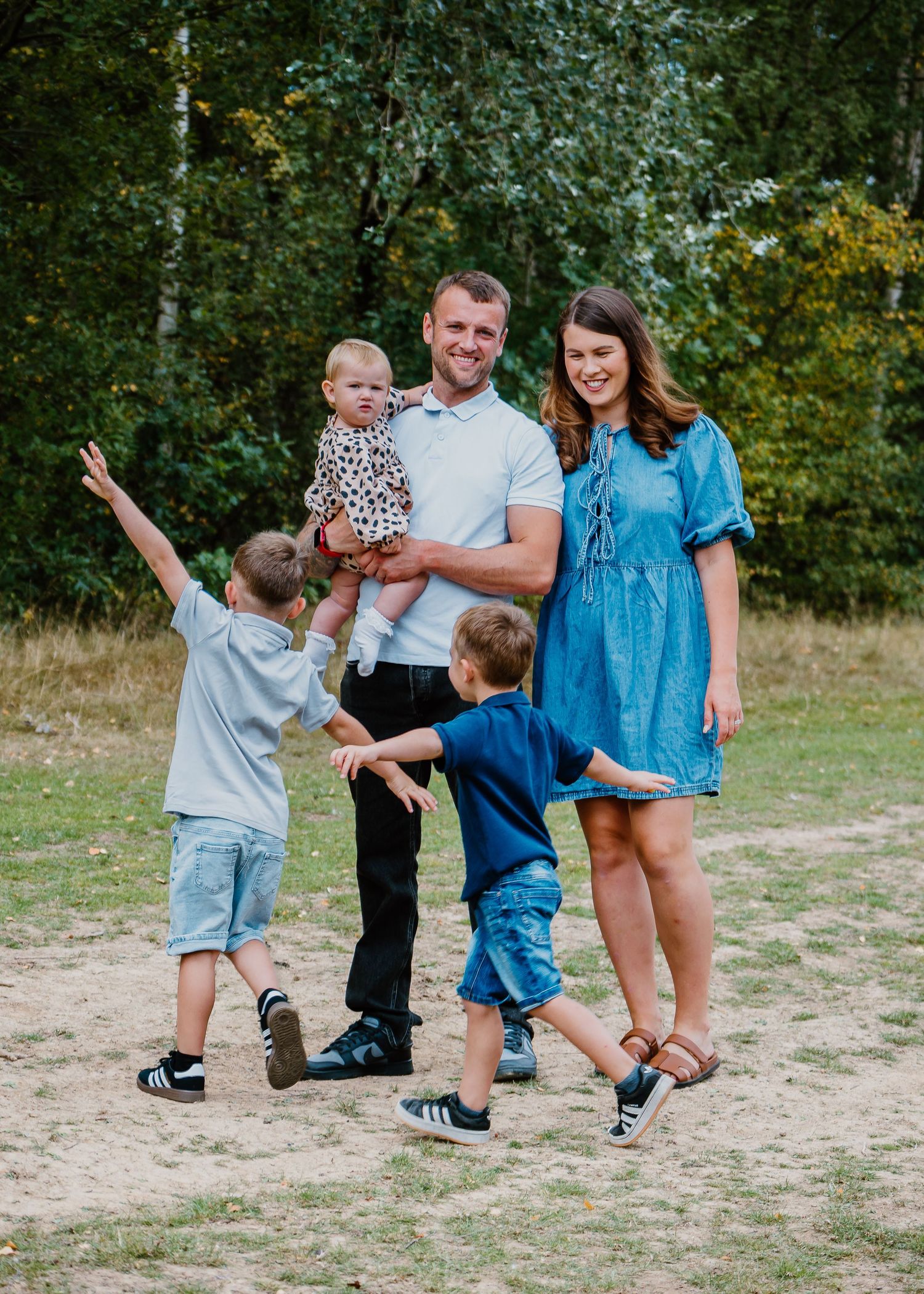 Family Photoshoot - Casual family photoshoot outdoors with playful poses and interactions.