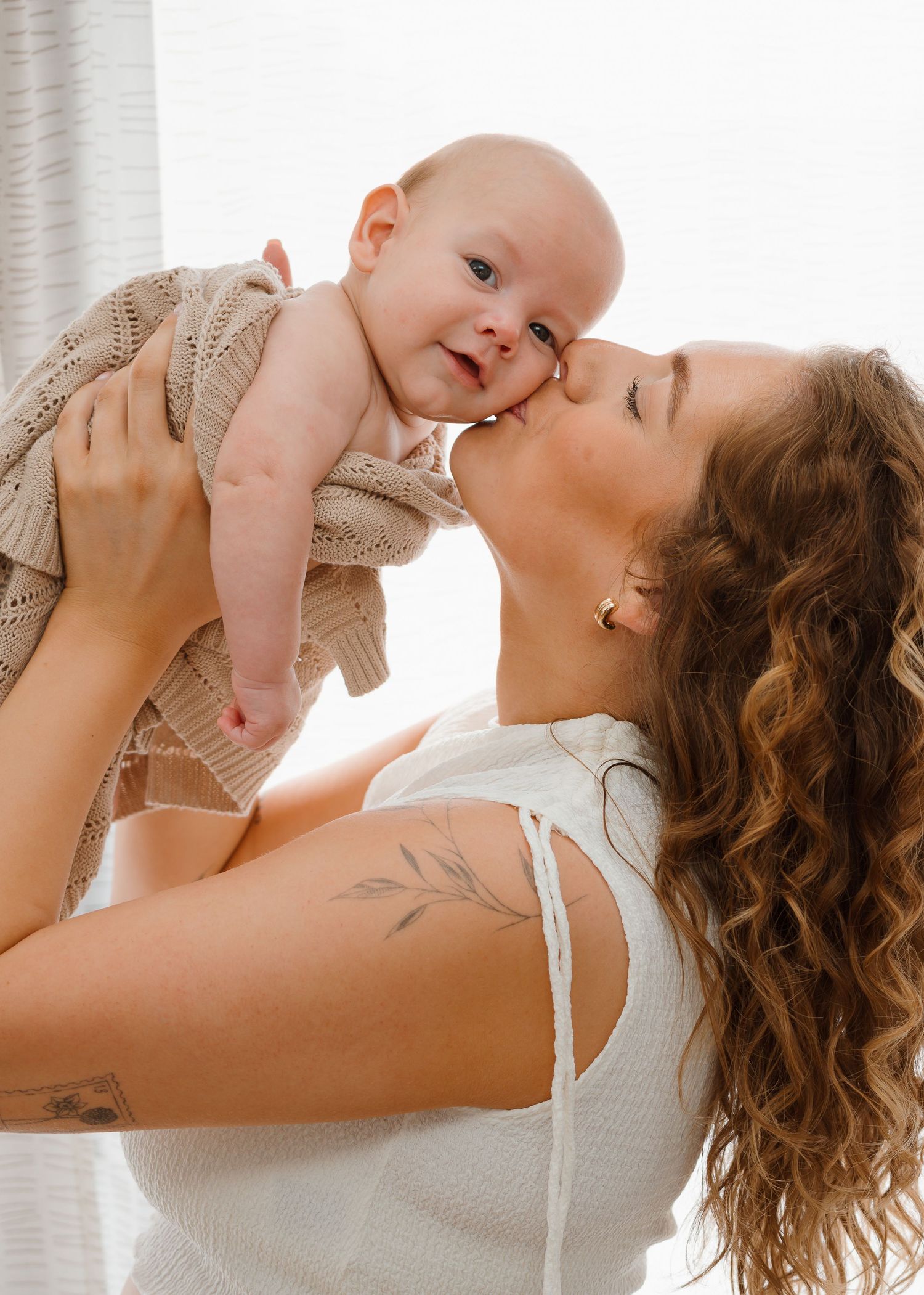 Newborn Photography - A tender moment captured in three photos showing affectionate interaction between parent and baby in natural light.