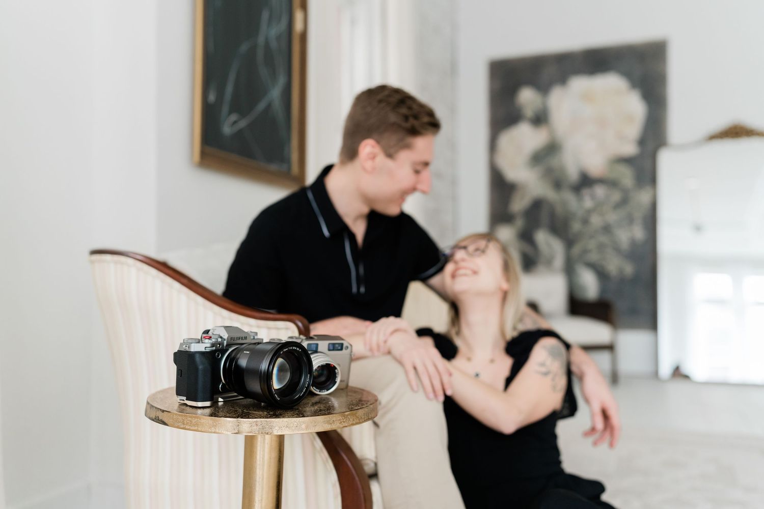 Two dancers perform an intimate duet with a camera visible on a side table.