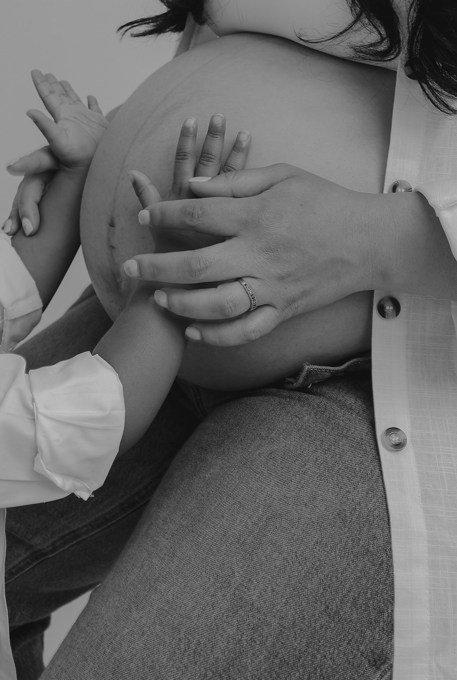 Close-up series of hands performing a gentle massage therapy treatment on a patient resting on a grey surface.