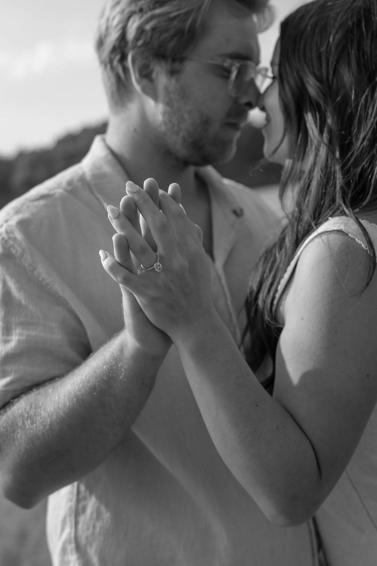 A romantic black and white photo sequence showing a couple sharing an intimate kiss.