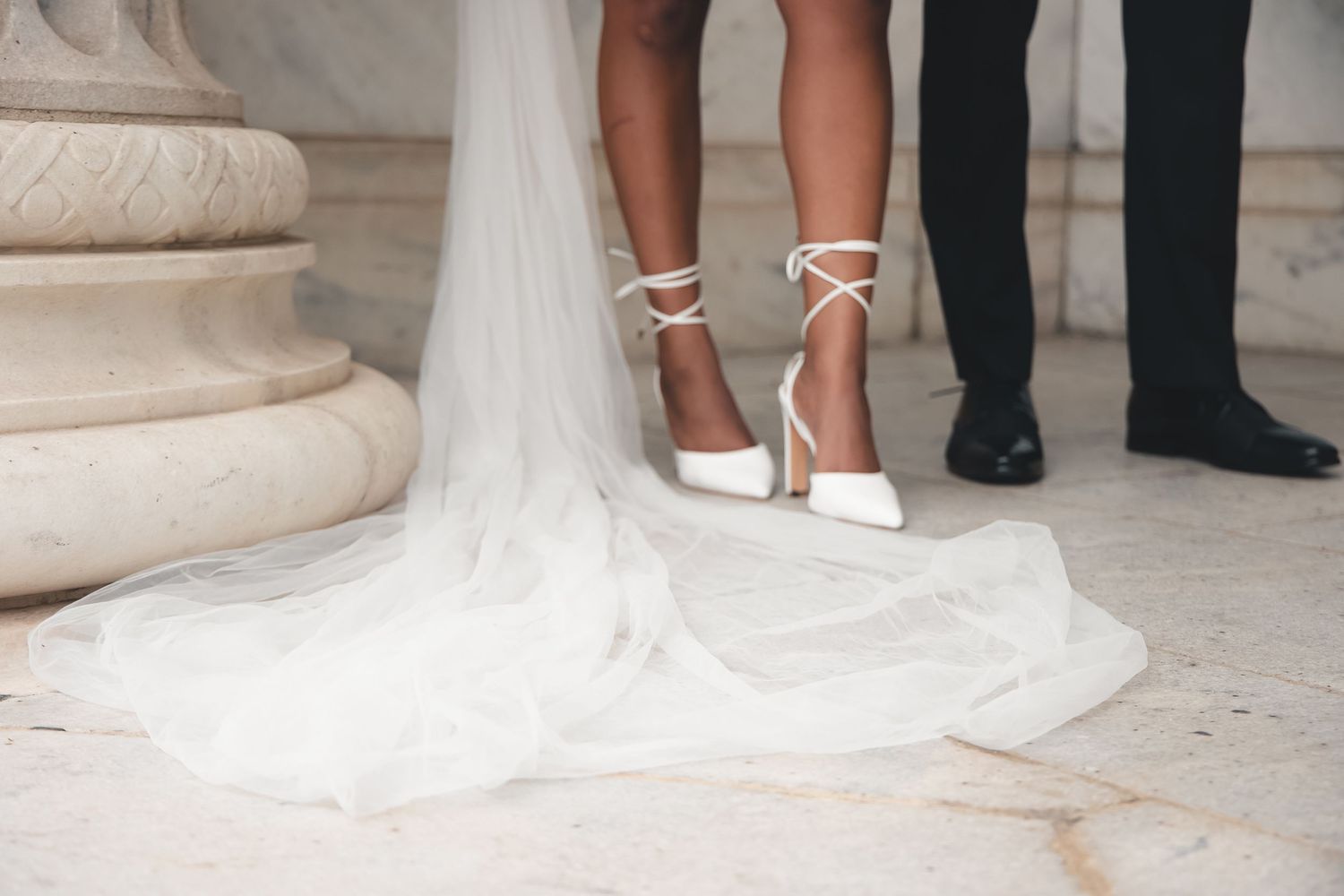 Bride’s lace-up heels and veil beside groom at Cleveland Museum of Art. Timeless Northeast Ohio wedding photography.