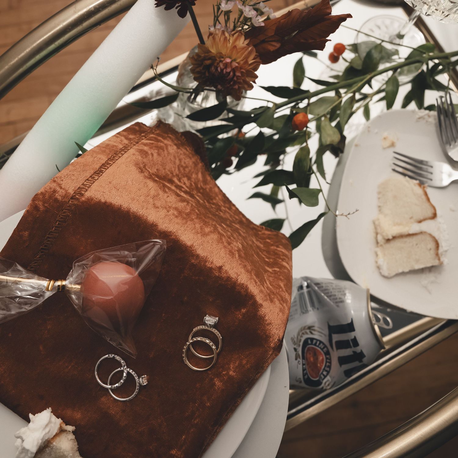 A detail shot that tells the story—wedding rings, cake crumbs, and a Miller Lite toast. Perfectly candid wedding day vibes in Miami, Florida