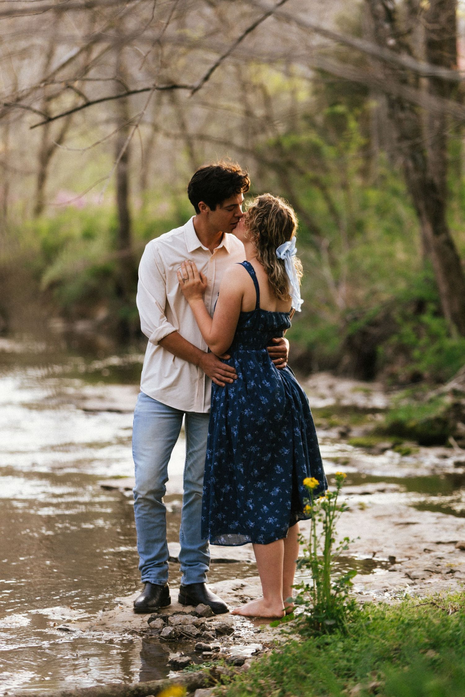 couple at creek kissing
