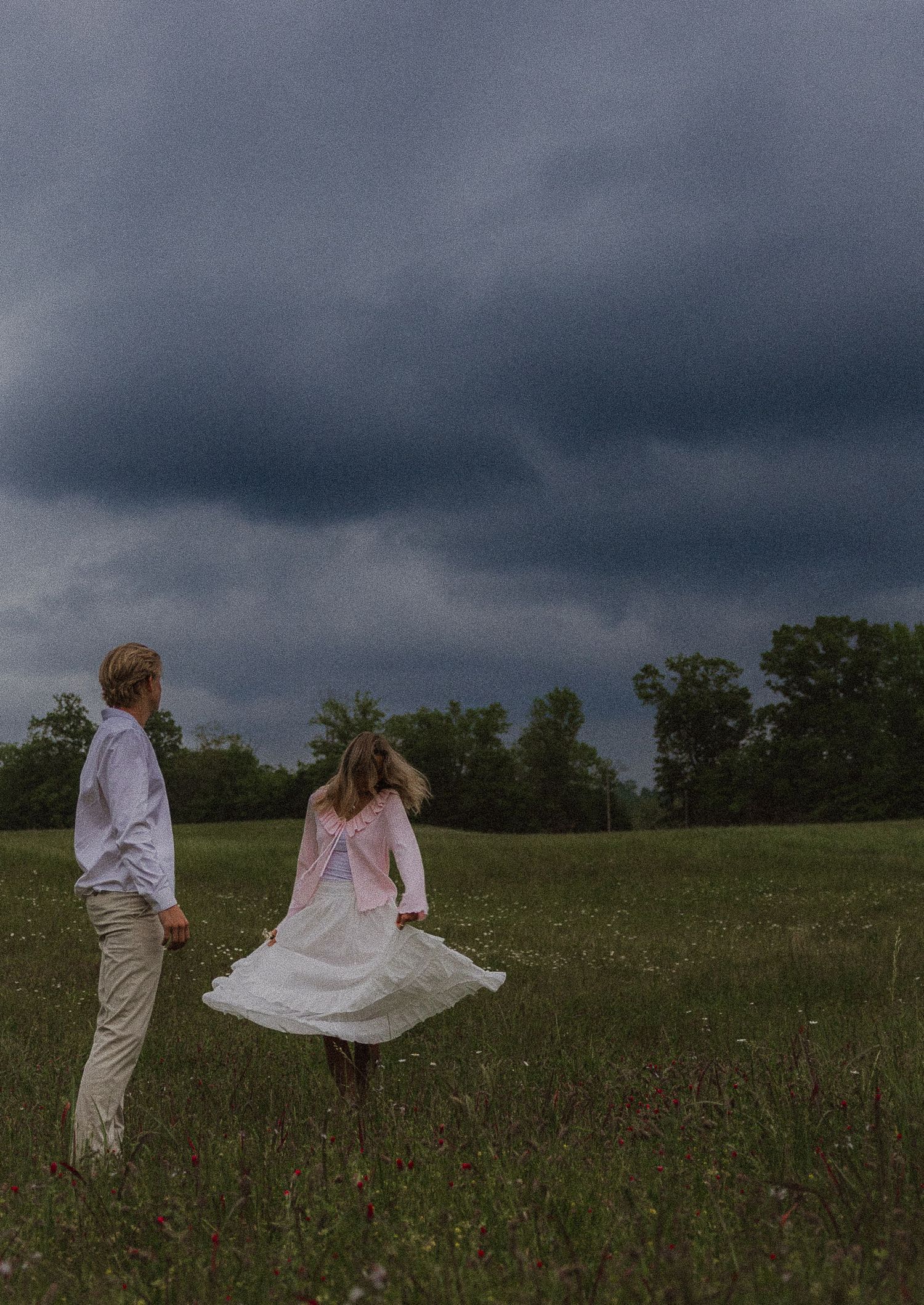 girl twirling wot stormy clouds