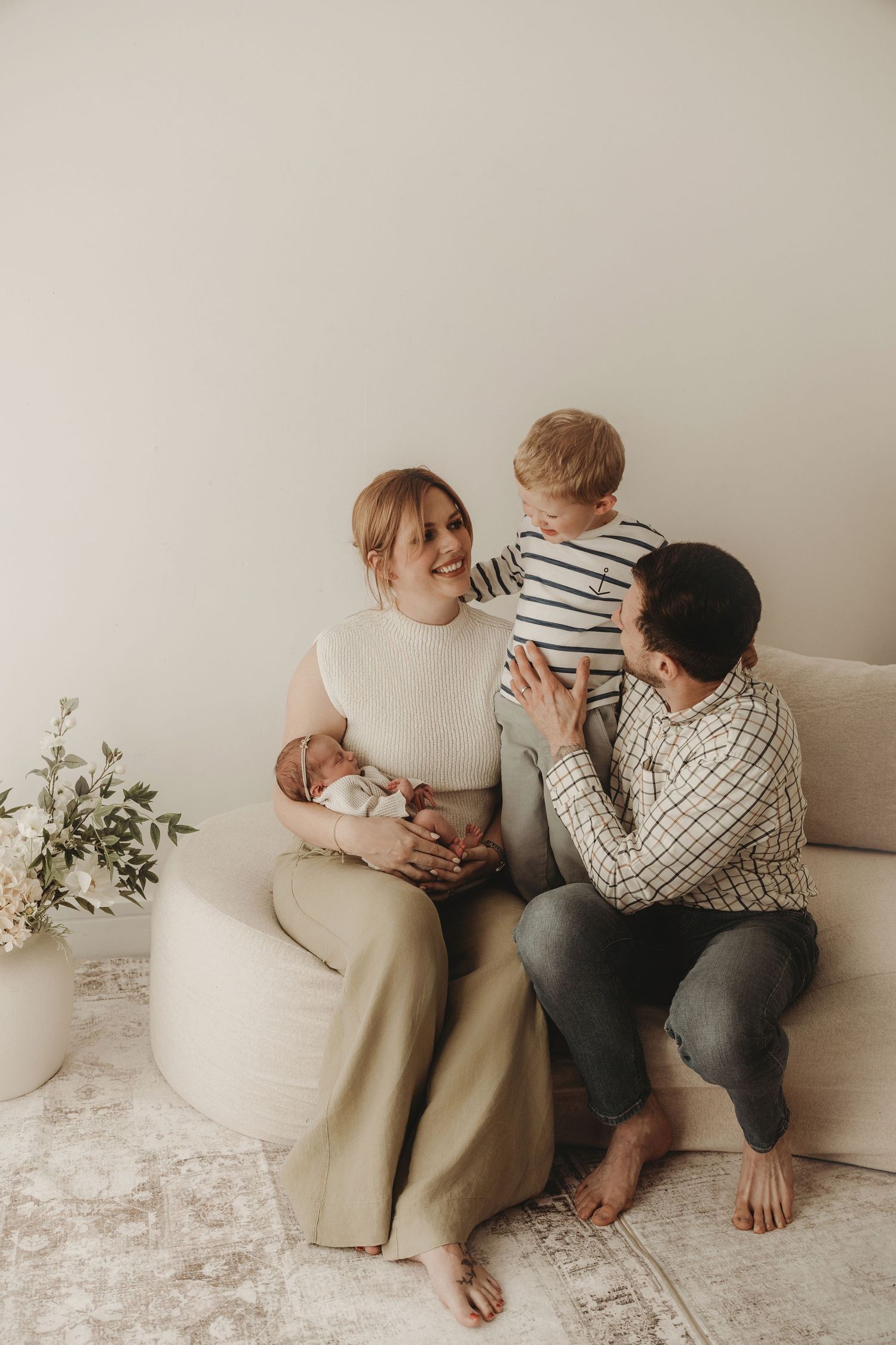 Mother and young child sharing a cuddle during a natural family photography session.