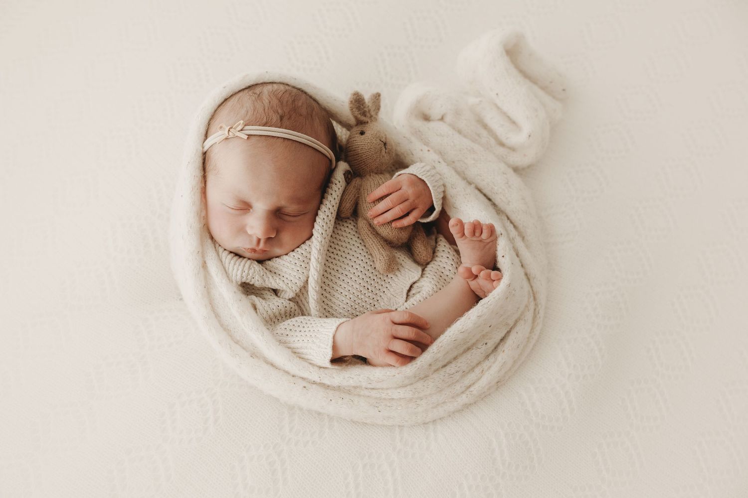 Newborn baby sleeping peacefully during a studio photography session.