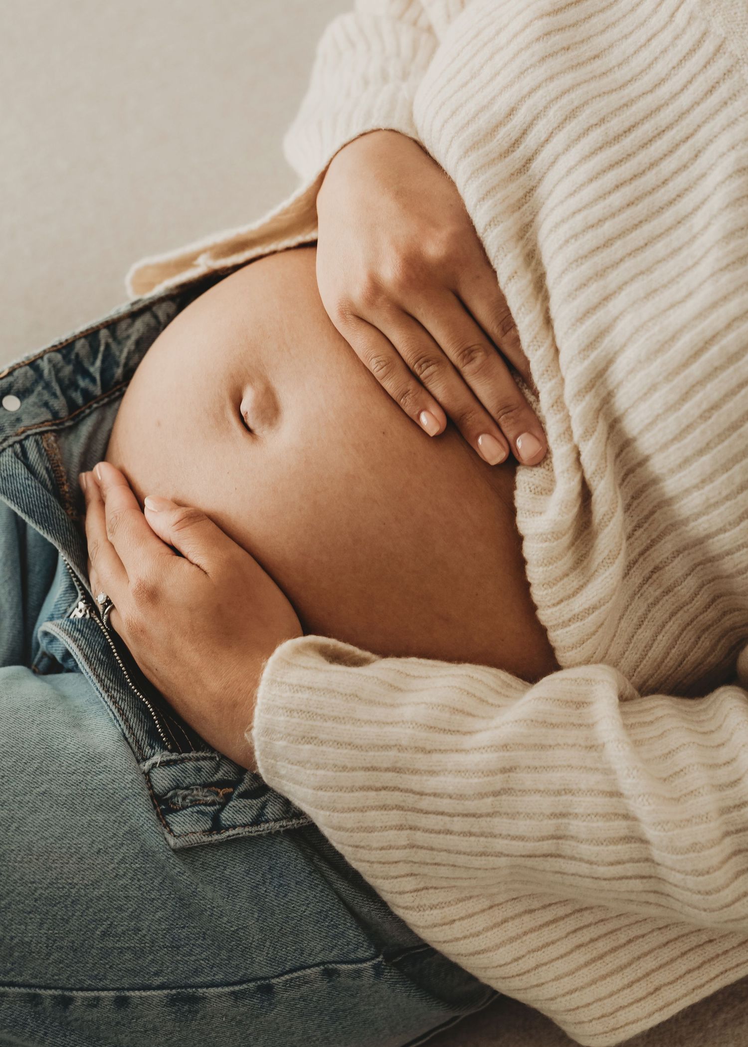 Close-up maternity photography highlighting a growing baby bump.