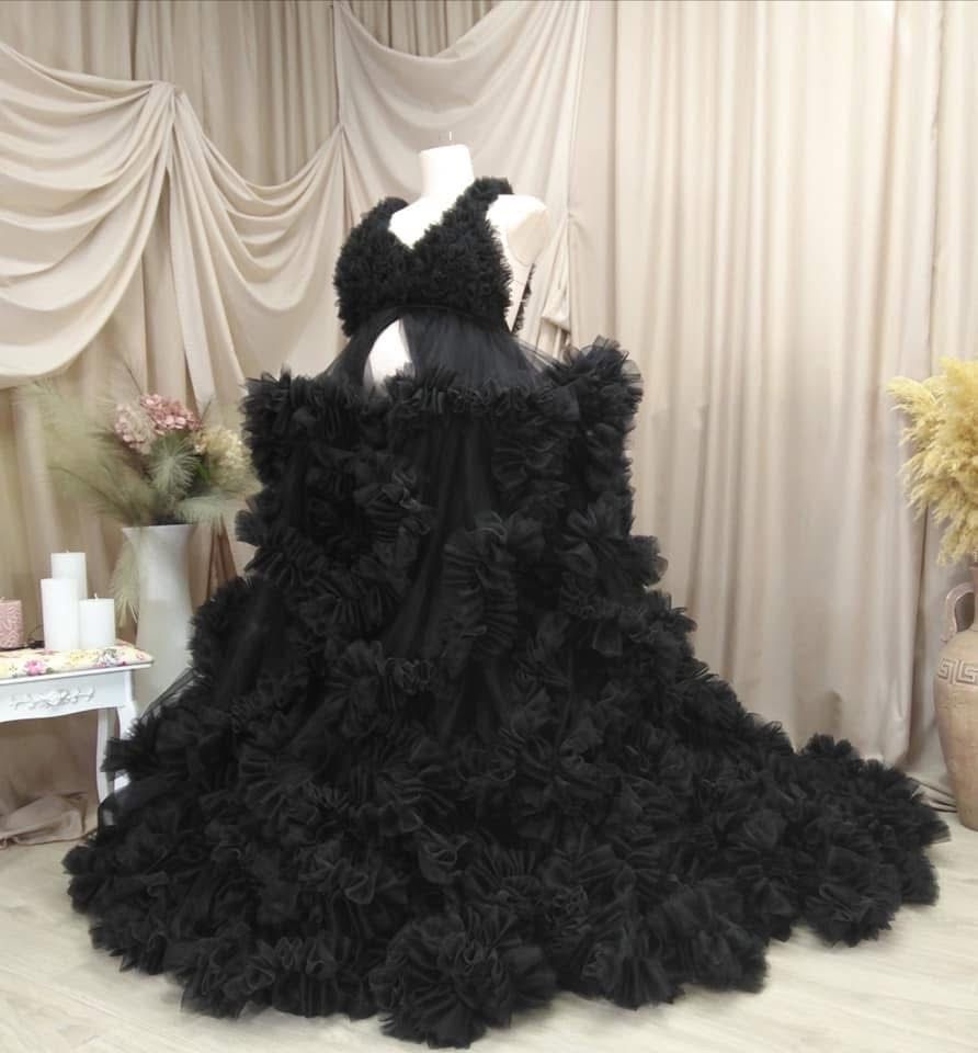 Dramatic black ruffled tulle maternity gown displayed on a mannequin.