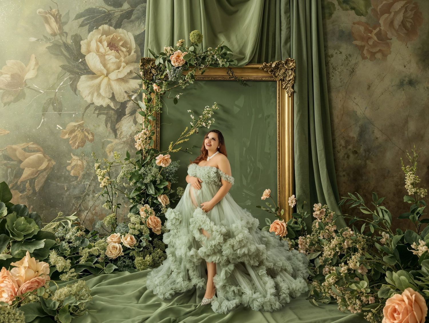 Woman in green tulle gown surrounded by roses beside ornate gold frame on floral backdrop.