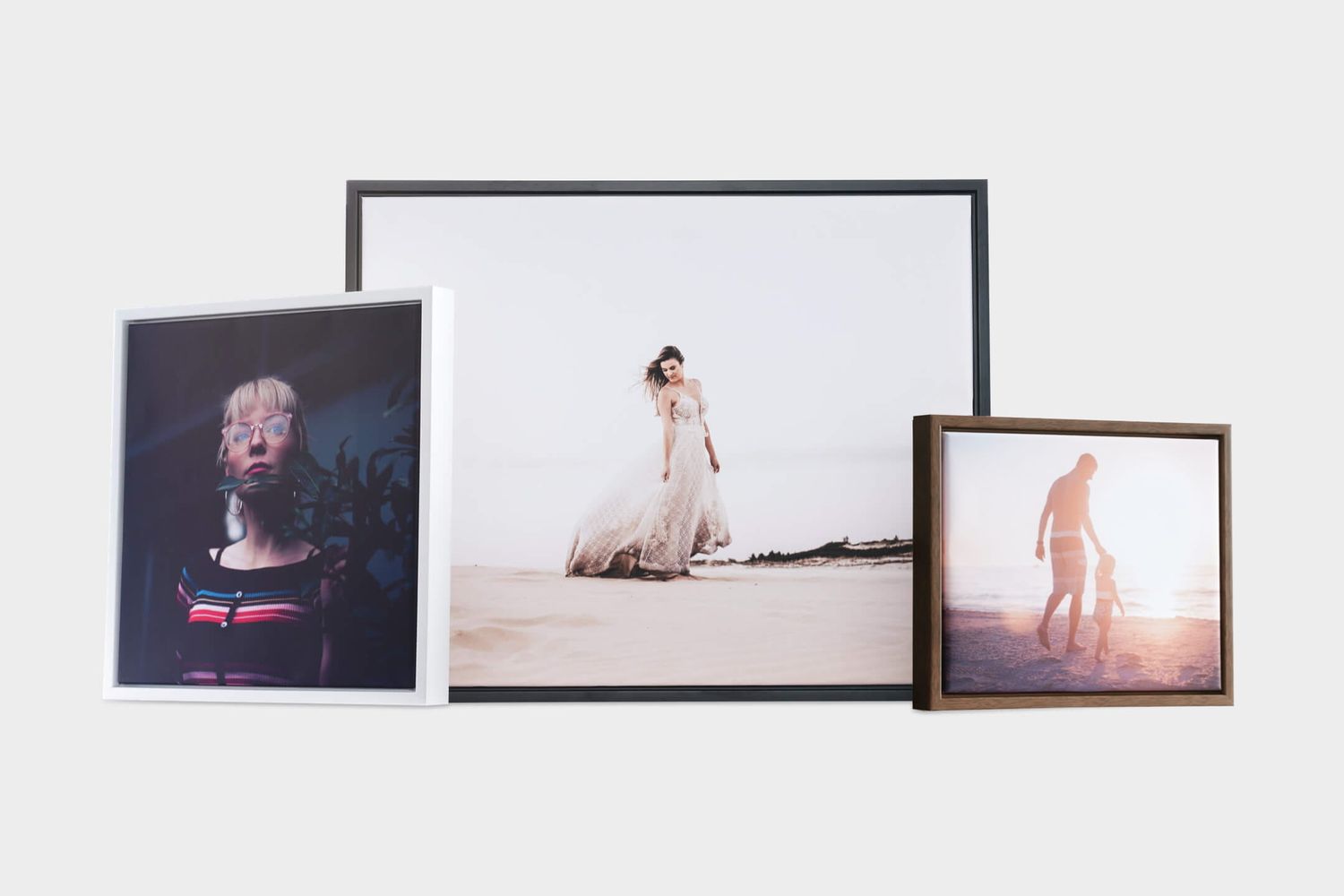 Three framed photos displayed together, featuring portrait, bridal, and beach photography prints in various frame styles.