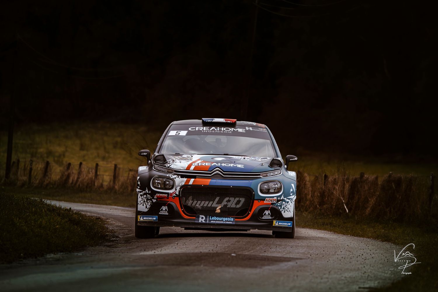 Racing Porsches with custom liveries photographed in moody lighting conditions.