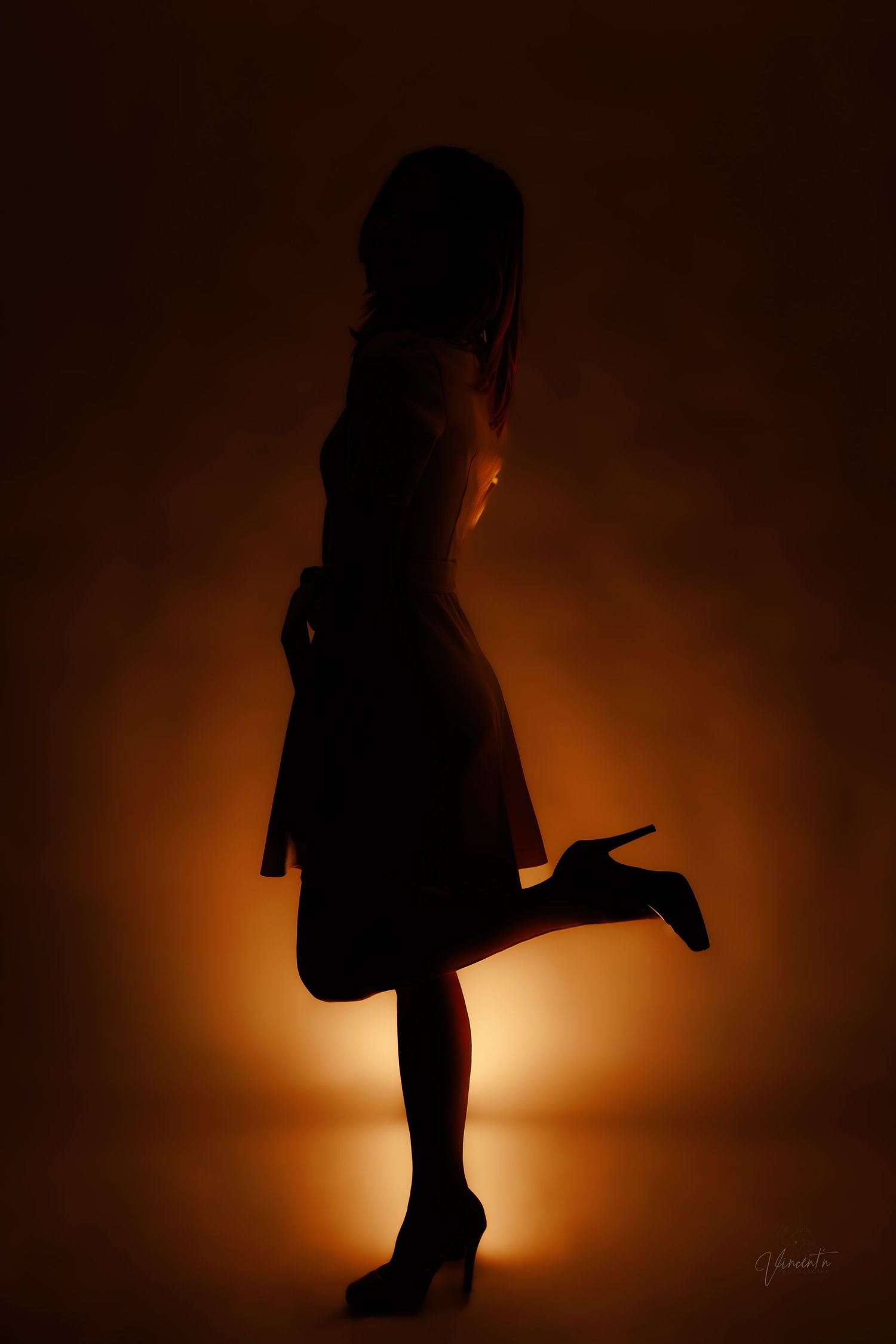 Dramatic silhouette sequence against warm orange backlight showing dynamic poses.