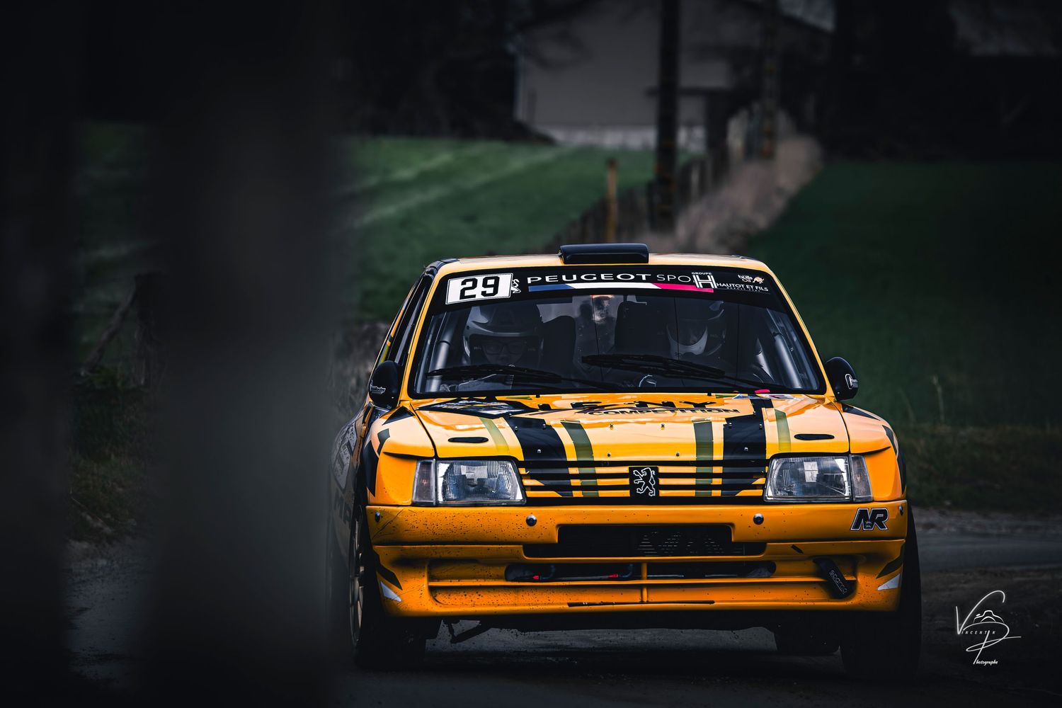 Orange and black racing cars lined up in a dramatic low-light setting.