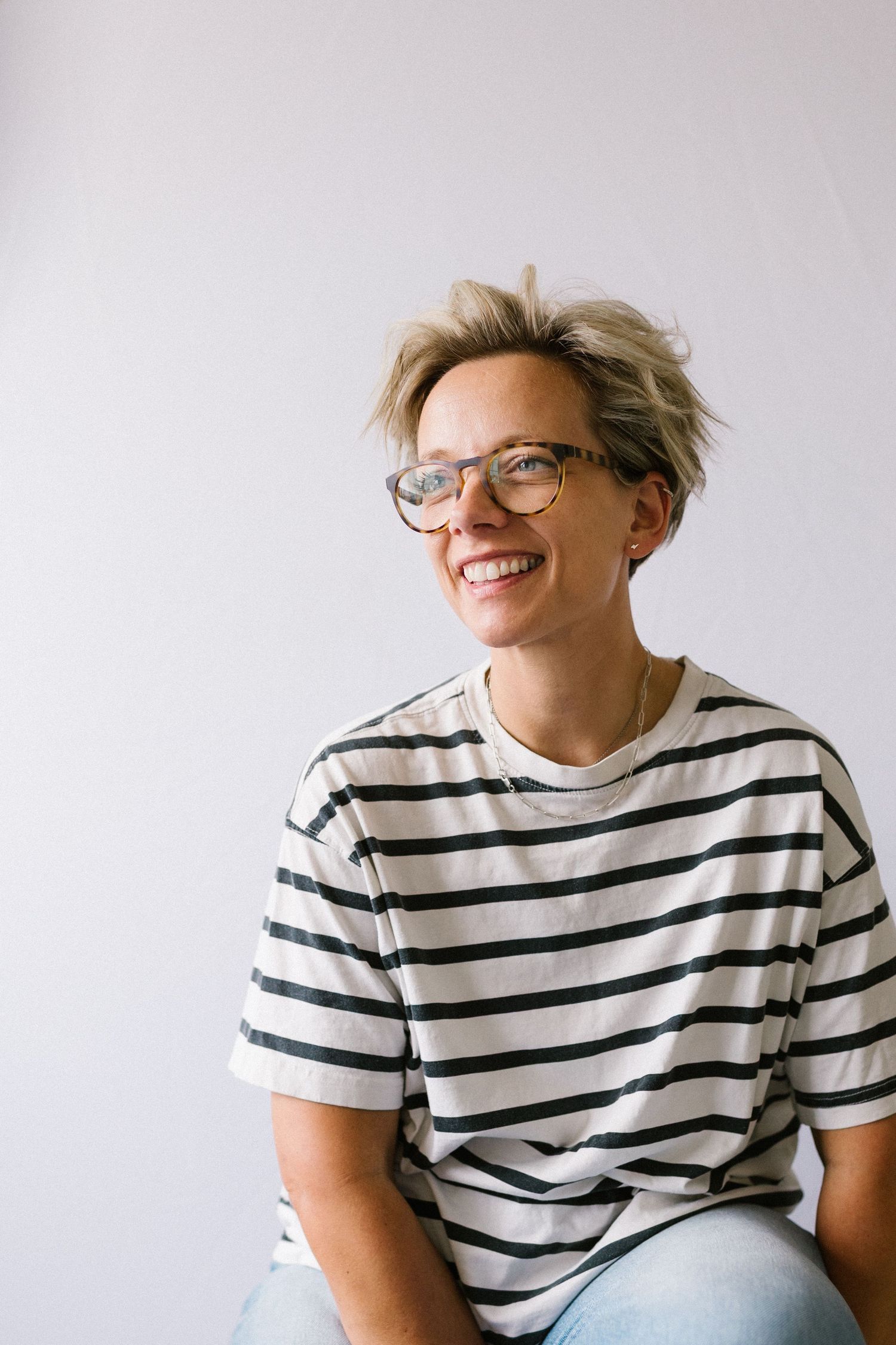 A series of candid shots showing someone wearing a black and white striped t-shirt against a light background.