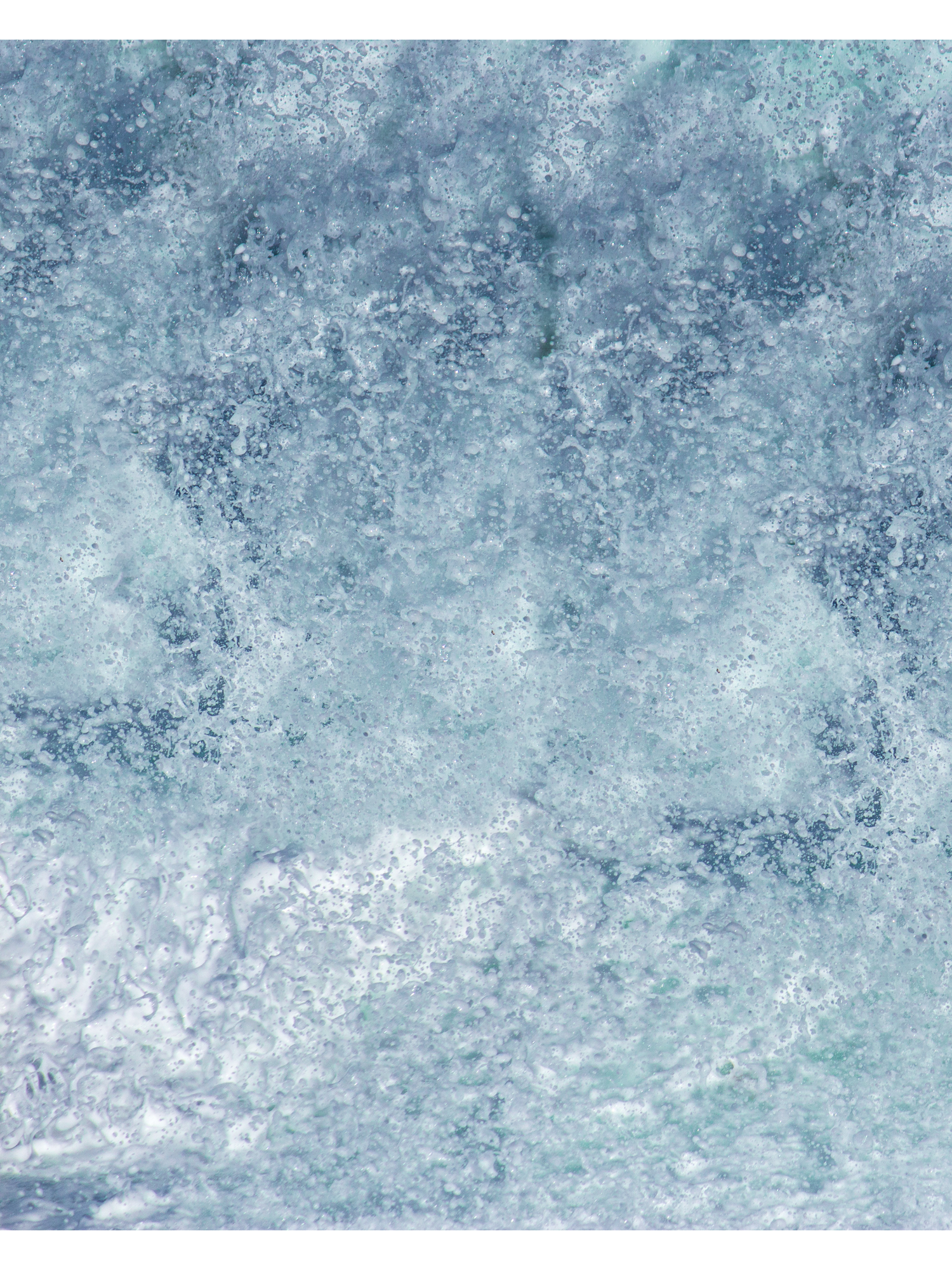Abstract blue and white watercolor texture with splattered paint effect creates a dreamy winter atmosphere.