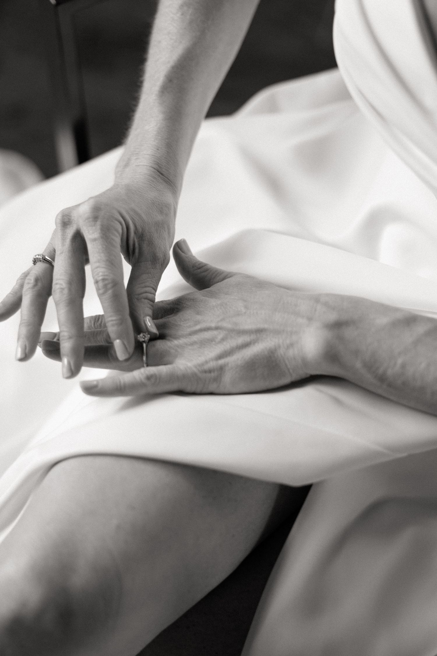 Black and white close-up photos showing hands performing therapeutic massage techniques on skin.